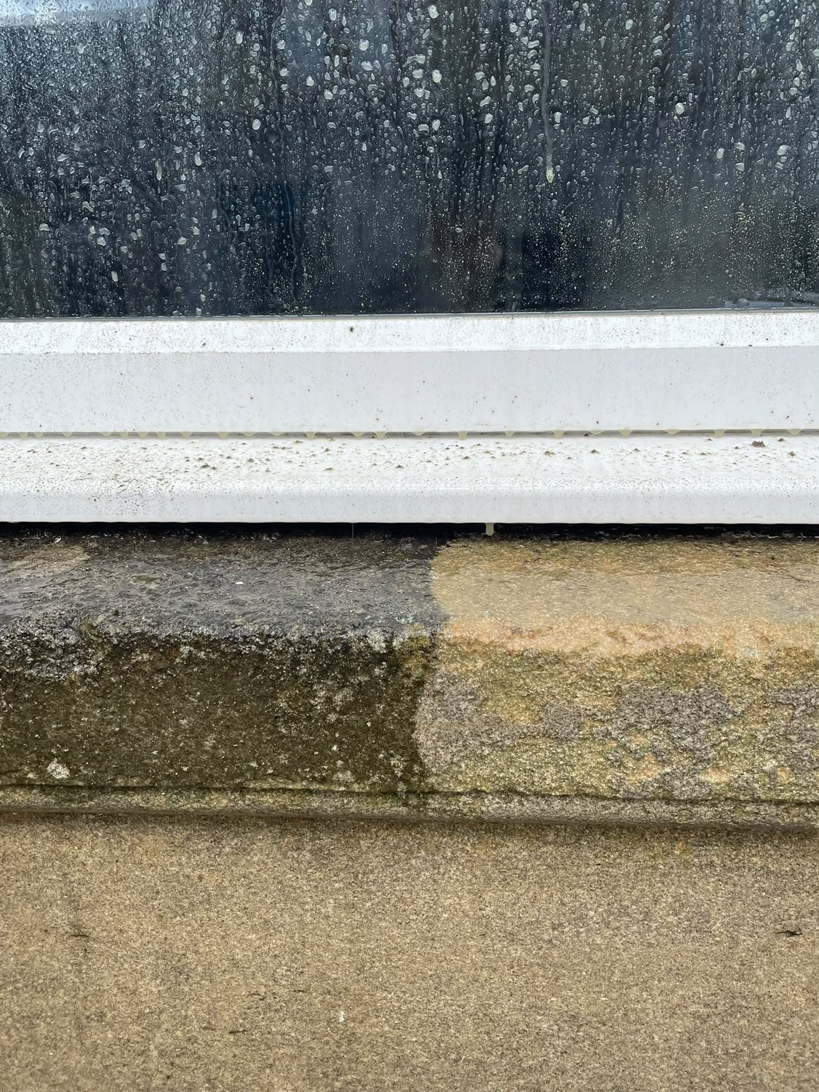 Stone window sill half cleaned, showing the before and after